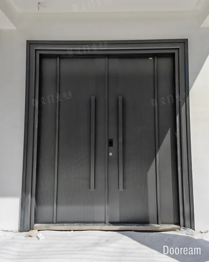 Charcoal-grey fluted double door with long vertical pull handles, installed at a client's home